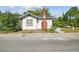 Traditional home featuring a brick chimney and inviting curb appeal at 702 W Virginia Ave, Tampa, FL 33603