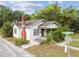 Charming single Gathering home featuring a red brick chimney and covered porch entrance at 702 W Virginia Ave, Tampa, FL 33603