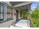 Inviting front porch with security features, and metal hand railing showcasing the entrance to the home at 702 W Virginia Ave, Tampa, FL 33603