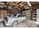 Spacious garage featuring a car, wood walls, and ample storage space at 702 W Virginia Ave, Tampa, FL 33603