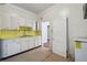 White kitchen cabinets and yellow countertops provide a vintage feel in this kitchen at 702 W Virginia Ave, Tampa, FL 33603
