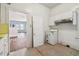 Kitchen with open doorway showing wood floors and white kitchen appliance at 702 W Virginia Ave, Tampa, FL 33603