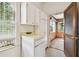 Laundry room featuring white cabinets and a window with natural light at 702 W Virginia Ave, Tampa, FL 33603