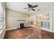 The living room features a decorative fireplace, ceiling fan and hardwood floors, leading to the next room at 702 W Virginia Ave, Tampa, FL 33603