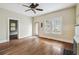 The living room has hardwood floors, a ceiling fan, and an exterior door that provides natural light at 702 W Virginia Ave, Tampa, FL 33603