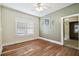 Cozy room with large windows has warm-toned hardwood floors and neutral walls at 702 W Virginia Ave, Tampa, FL 33603