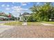 Street view of the property with a vintage brick road and mature shade trees at 702 W Virginia Ave, Tampa, FL 33603