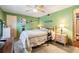 A cozy bedroom with green walls, carpeted floors, and a vintage feel at 7053 El Conquistador St, Zephyrhills, FL 33541
