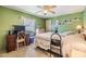 A cozy bedroom with green walls, carpeted floors, and a vintage feel at 7053 El Conquistador St, Zephyrhills, FL 33541