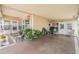 Spacious covered carport with ample seating, planters, and access to both the home and the backyard at 7053 El Conquistador St, Zephyrhills, FL 33541