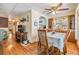 Dining area with hardwood floors, built-in shelving, and open layout to living area, perfect for entertaining at 7053 El Conquistador St, Zephyrhills, FL 33541