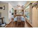Traditional dining room featuring wood floors, a ceiling fan and a table set for six at 7053 El Conquistador St, Zephyrhills, FL 33541