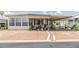 Charming single-story home with a covered carport and decorated porch, perfect for relaxing outdoors at 7053 El Conquistador St, Zephyrhills, FL 33541