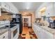 Open kitchen with white cabinets, laminate countertops, and black appliances, and breakfast area at 7053 El Conquistador St, Zephyrhills, FL 33541