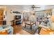 Spacious living room featuring an open layout, hardwood floors, and seamless transitions to dining and Gathering areas at 7053 El Conquistador St, Zephyrhills, FL 33541