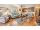 Cozy living room boasting wood floors, comfortable furniture, and a warm, welcoming atmosphere at 7053 El Conquistador St, Zephyrhills, FL 33541