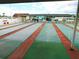 Community shuffleboard courts with multiple lanes and a covered seating area at 7053 El Conquistador St, Zephyrhills, FL 33541