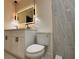 Updated bathroom featuring a dual sink vanity, illuminated mirror, and sleek, glass-enclosed shower at 733 Holly Ter, Brandon, FL 33511