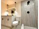 Updated bathroom featuring a dual sink vanity, illuminated mirror, and sleek, glass-enclosed shower at 733 Holly Ter, Brandon, FL 33511