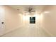 Bedroom with large window offering natural light, fan, and door leading to other areas at 733 Holly Ter, Brandon, FL 33511