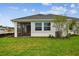 Beautiful backyard featuring a well-maintained lawn and the rear of the house at 755 Maldives Trl, Sarasota, FL 34234