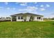 Expansive backyard with lush green grass and a partial view of the home's exterior at 755 Maldives Trl, Sarasota, FL 34234