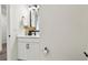 Modern half-bathroom with stylish black hardware and a decorative vase and foliage at 755 Maldives Trl, Sarasota, FL 34234