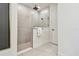 Modern bathroom features a glass-enclosed shower with matte black fixtures and neutral tile at 755 Maldives Trl, Sarasota, FL 34234