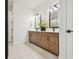 Elegant bathroom with double vanity, sleek fixtures, and ample storage space at 755 Maldives Trl, Sarasota, FL 34234