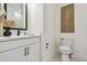 Well-lit half bath with a modern vanity, black fixtures, and decorative wall art at 755 Maldives Trl, Sarasota, FL 34234