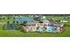 Aerial view of a community pool and amenity center with tennis courts and a picturesque pond at 755 Maldives Trl, Sarasota, FL 34234