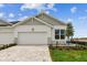 Charming single-story home featuring a two-car garage, attractive landscaping, and a welcoming brick driveway at 755 Maldives Trl, Sarasota, FL 34234