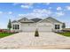 The house features a two-car garage, a brick driveway, and well-manicured landscaping at 755 Maldives Trl, Sarasota, FL 34234