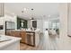 Island kitchen with stainless steel appliances, views into a living room, and hardwood floors at 755 Maldives Trl, Sarasota, FL 34234