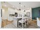 Modern kitchen with white cabinetry, an island with seating, and stainless steel appliances at 755 Maldives Trl, Sarasota, FL 34234