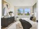 Bright bedroom with a view features modern decor, large windows, and comfortable furnishings at 755 Maldives Trl, Sarasota, FL 34234