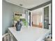 Well-lit office features a large desk, modern decor, and a view into the living area at 755 Maldives Trl, Sarasota, FL 34234