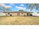 Large backyard featuring a well maintained lawn, a white fence, and a patio area for entertaining at 812 Regent Circle S, Brandon, FL 33511