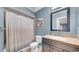 Bathroom featuring a shower with curtain, granite countertop sink, and cow art at 812 Regent Circle S, Brandon, FL 33511