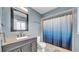 Well-lit bathroom with a granite-topped vanity, a modern sink, and a shower with stylish curtain at 812 Regent Circle S, Brandon, FL 33511