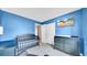 Blue Bedroom with crib, dresser, closet and TV at 812 Regent Circle S, Brandon, FL 33511