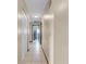Hallway with tile flooring and neutral walls, leading to various rooms in the home at 812 Regent Circle S, Brandon, FL 33511