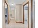Hallway with neutral tones, tiled floors, and multiple doorways to different rooms at 812 Regent Circle S, Brandon, FL 33511