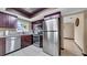 Well-lit kitchen with dark wood cabinets, stainless steel appliances, and a skylight at 812 Regent Circle S, Brandon, FL 33511
