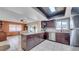 Modern kitchen with dark cabinetry, tile floors, an island, and stainless steel appliances at 812 Regent Circle S, Brandon, FL 33511