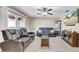 Comfortable living room featuring leather furniture, a ceiling fan, and a large window for natural light at 812 Regent Circle S, Brandon, FL 33511