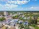 An aerial view of a neighborhood with lush trees, blue skies, and varied housing styles at 834 26Th N Ave, St Petersburg, FL 33704