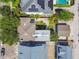 An aerial view of a neighborhood displaying rooftops, greenery, and a blue swimming pool at 834 26Th N Ave, St Petersburg, FL 33704