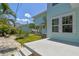 Charming backyard offers a stone patio, lush lawn, tropical plants, and beautiful garden spaces at 834 26Th N Ave, St Petersburg, FL 33704