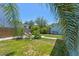 Well-maintained backyard featuring a grassy area, garden, stone path, and outdoor seating at 834 26Th N Ave, St Petersburg, FL 33704